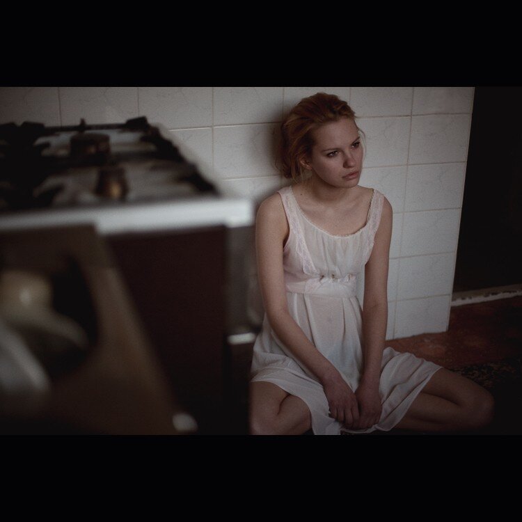 woman in white dress sitting on floor
