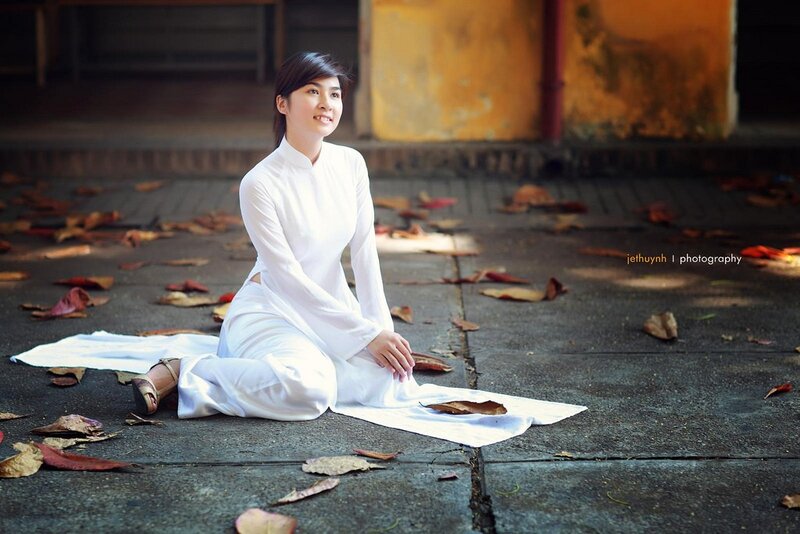 Woman in white dress sitting on ground