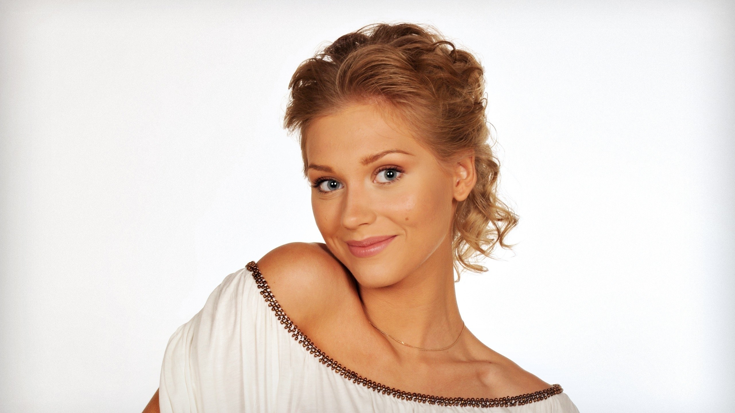 woman in white dress smiling