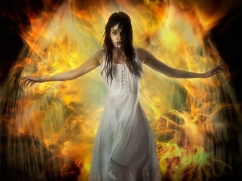 woman in white dress surrounded by fire