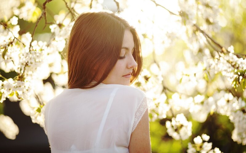woman in white dress under blossoms