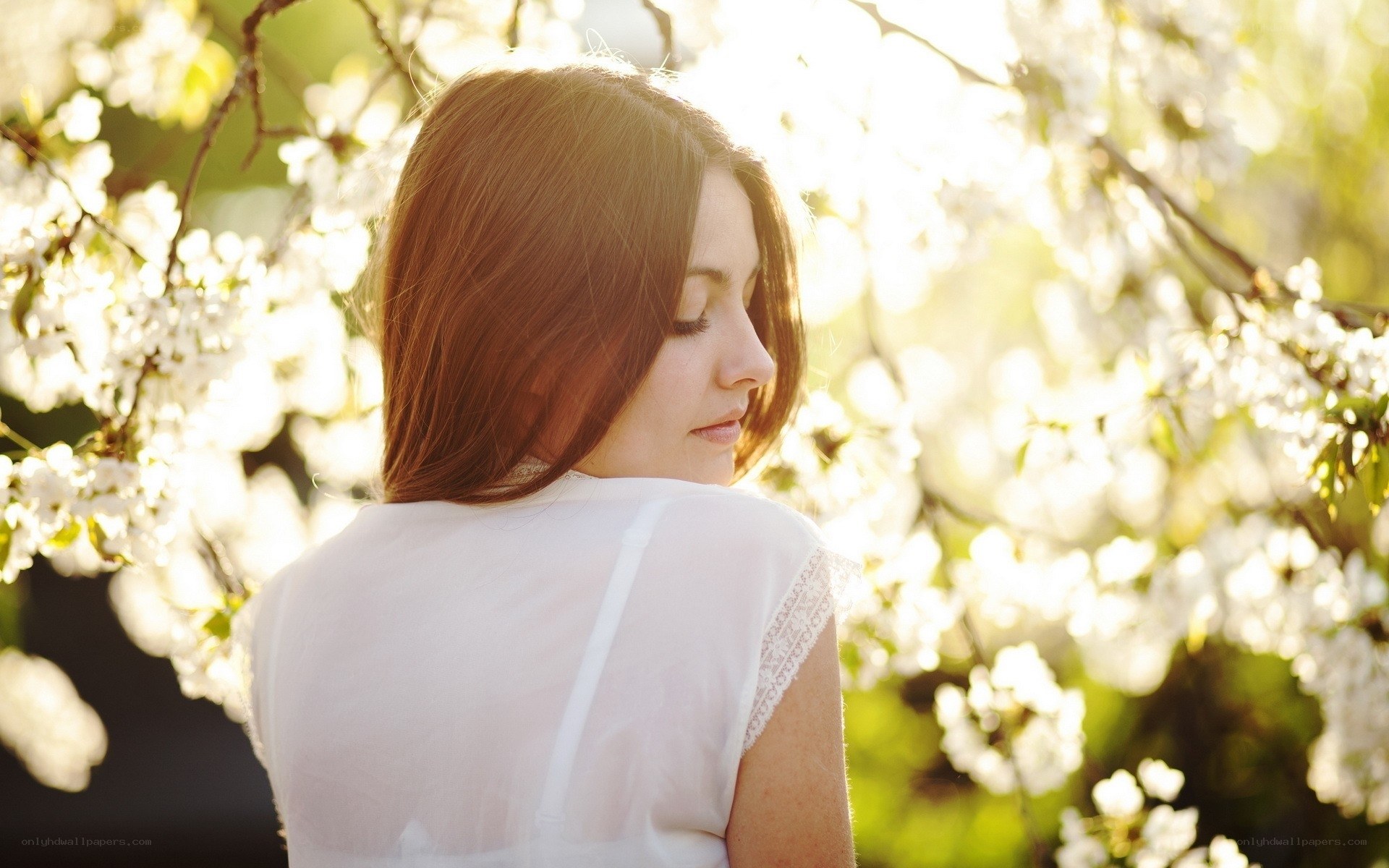 woman in white dress under blossoms
