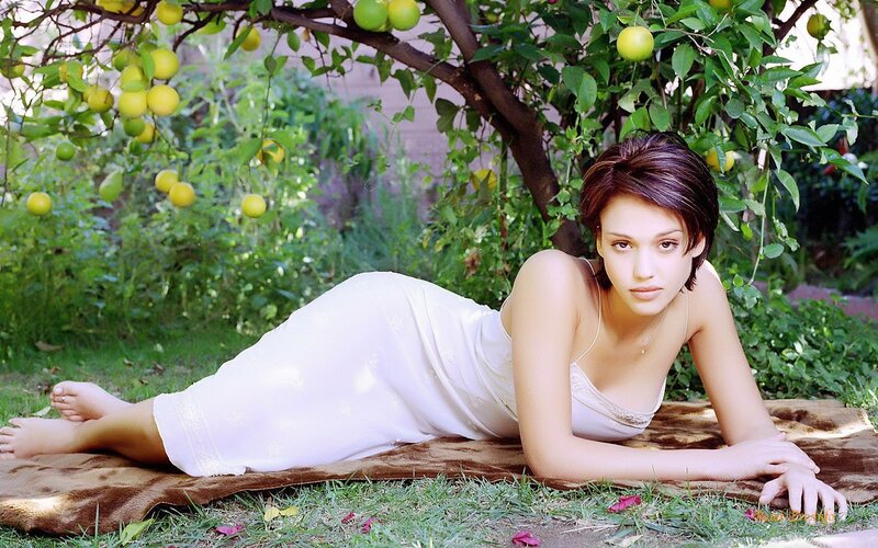 woman in white dress under lemon tree