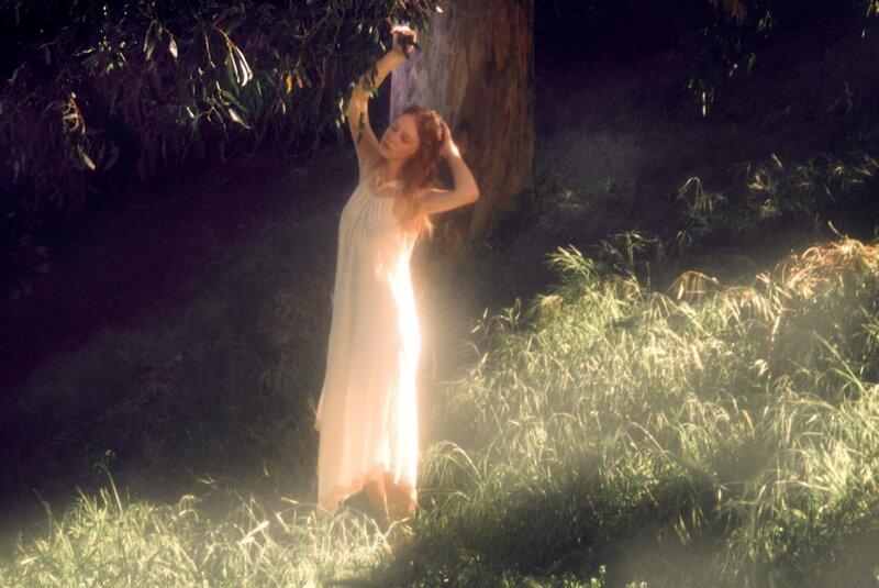 Woman in white dress under tree