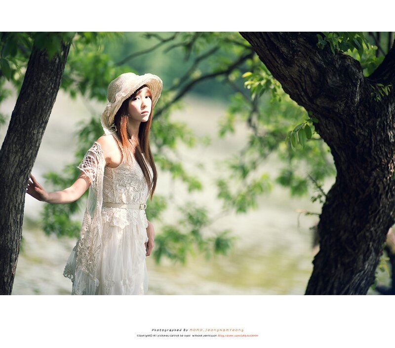 woman in white dress under trees