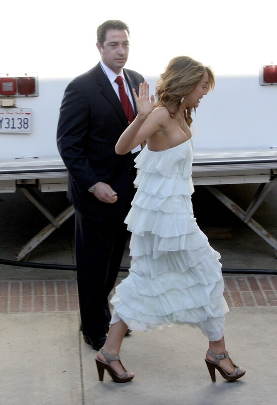 Woman in white dress waving