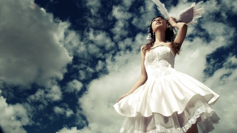 woman in white dress with angel wings