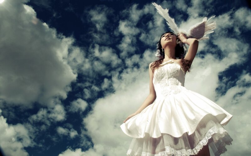 Woman in white dress with angel wings