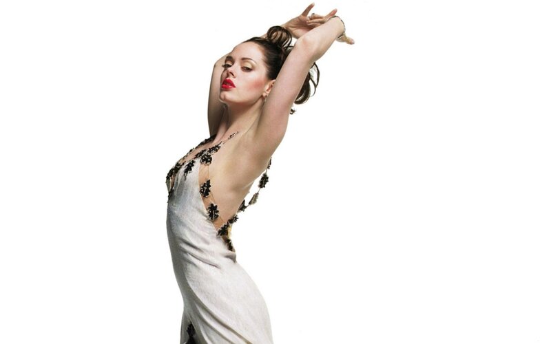 woman in white dress with arms raised