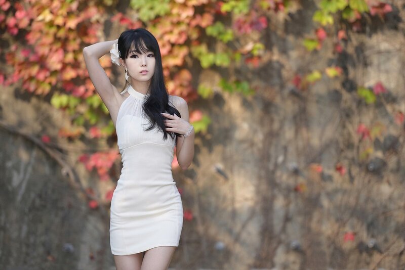 woman in white dress with autumn leaves
