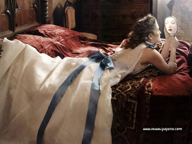 woman in white dress with blue ribbon