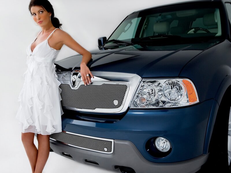 woman in white dress with blue suv