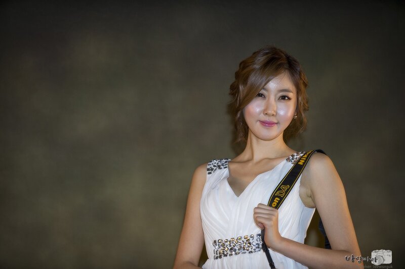 woman in white dress with camera strap