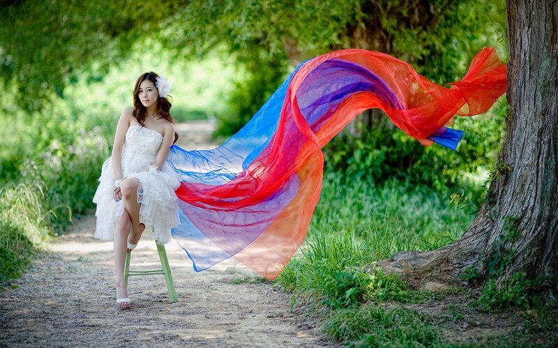 Woman in white dress with colorful scarf