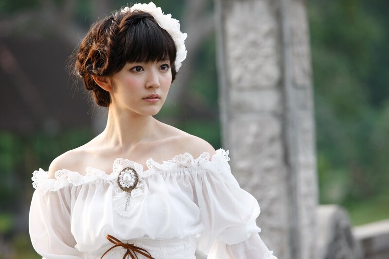woman in white dress with floral headpiece