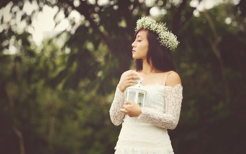 woman in white dress with flower crown