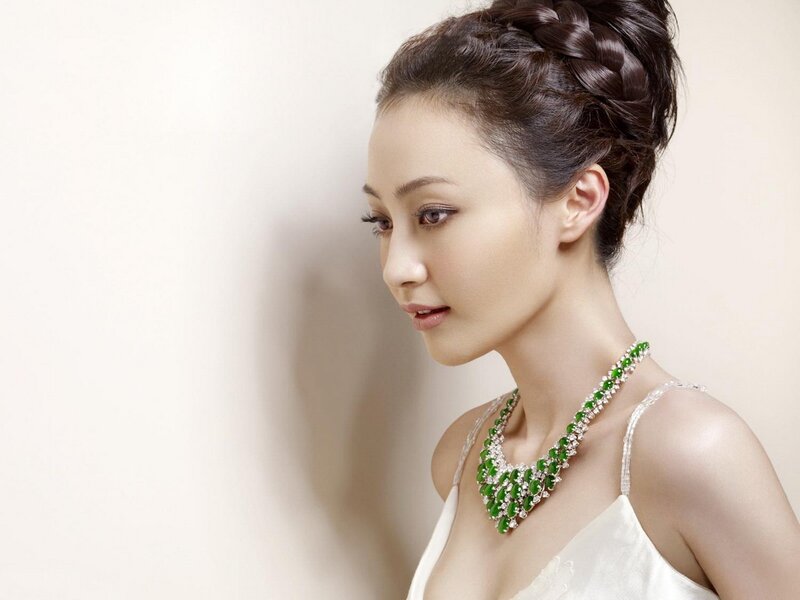 woman in white dress with green necklace