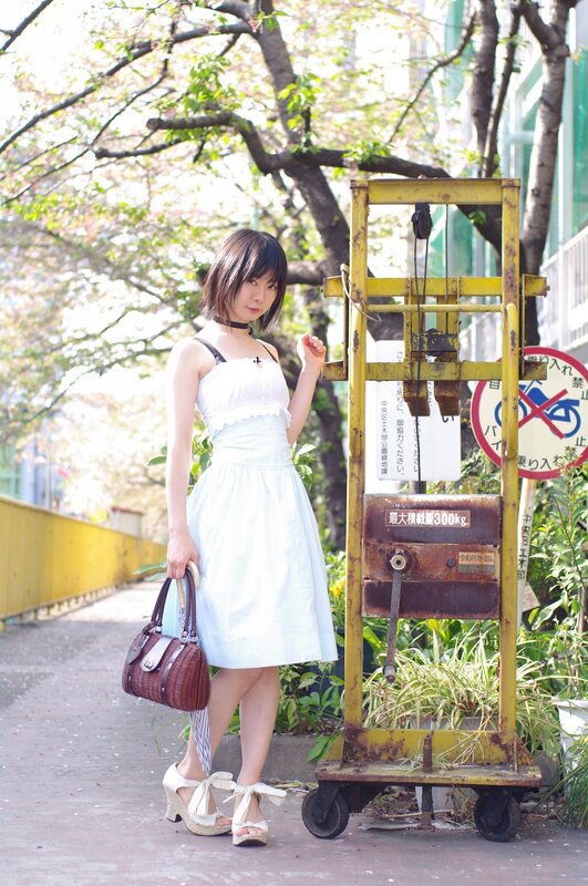 Woman in white dress with handbag