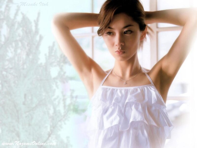 woman in white dress with hands behind head