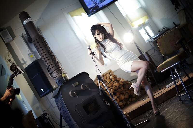 woman in white dress with microphone
