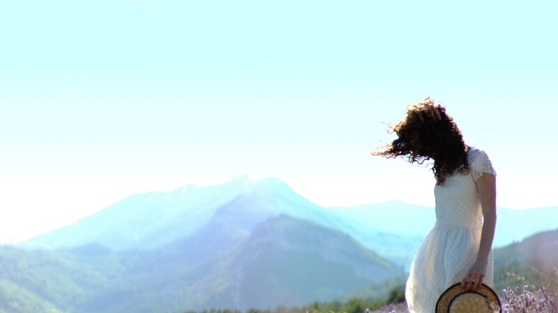 Woman in white dress with mountains