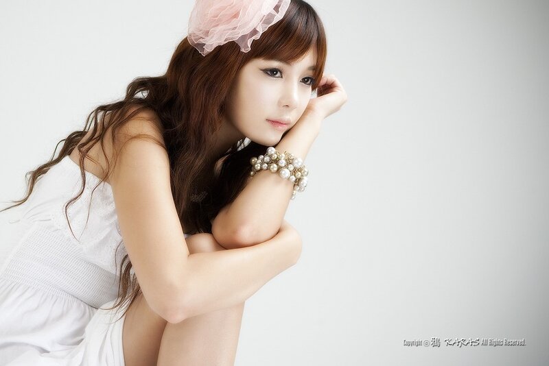 woman in white dress with pearl bracelet