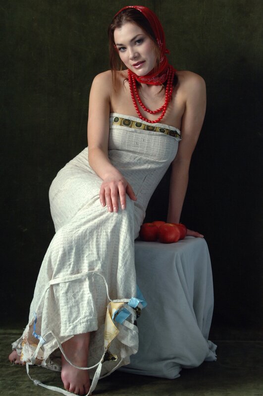 woman in white dress with red headscarf