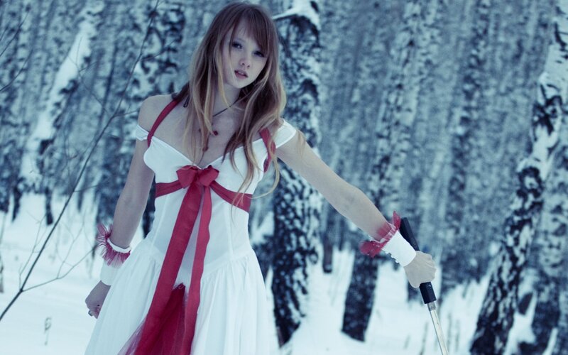 woman in white dress with red ribbon