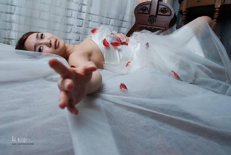 woman in white dress with rose petals
