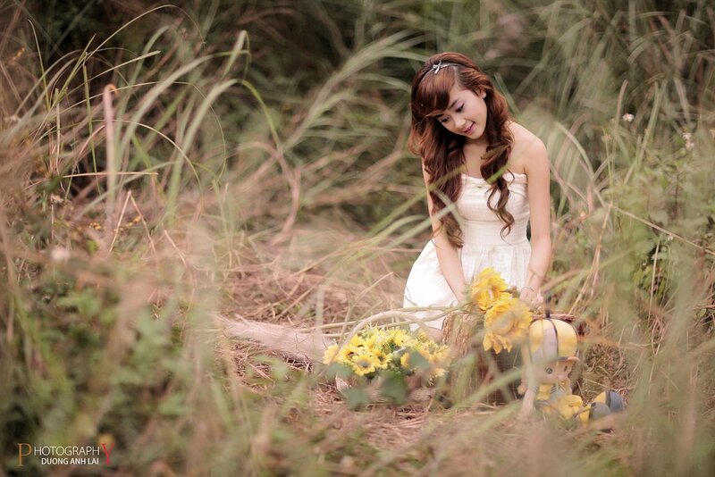 Woman in white dress with sunflowers