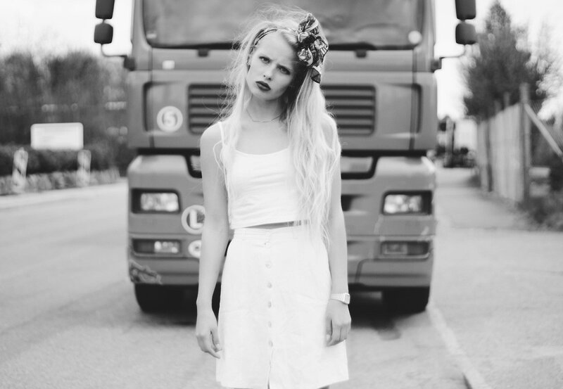 Woman in white dress with truck