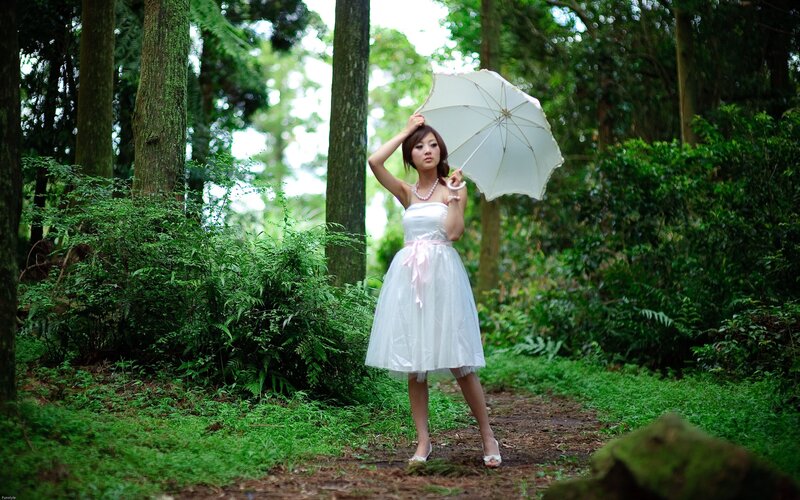Woman in white dress with umbrella