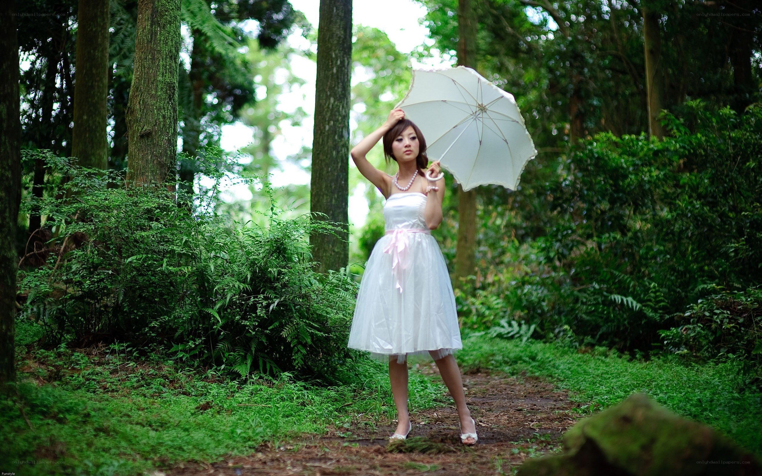 Woman in white dress with umbrella