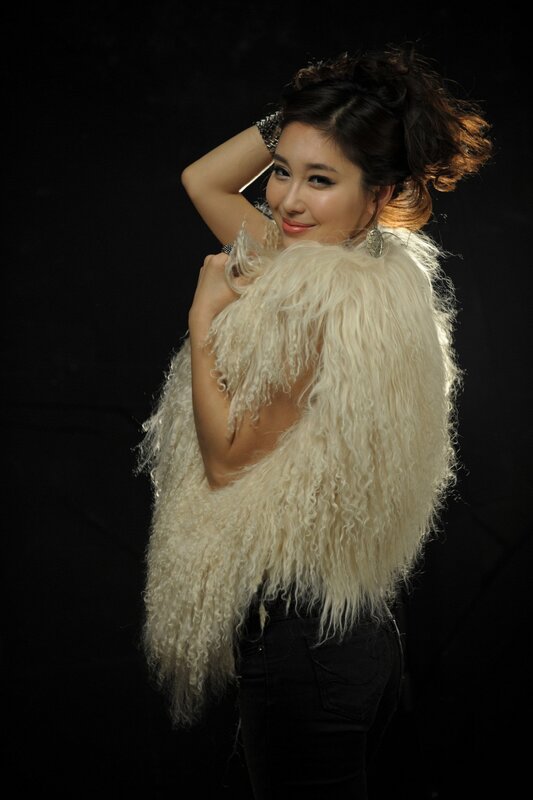 woman in white fur vest