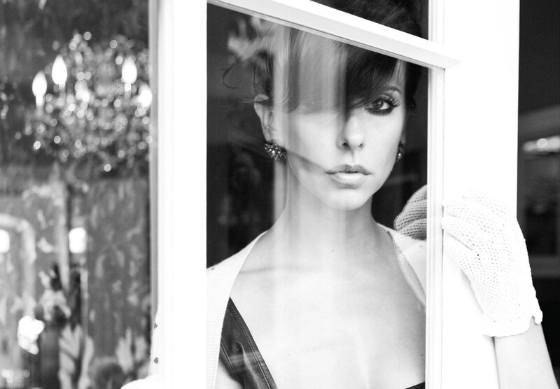 woman in white glove by window