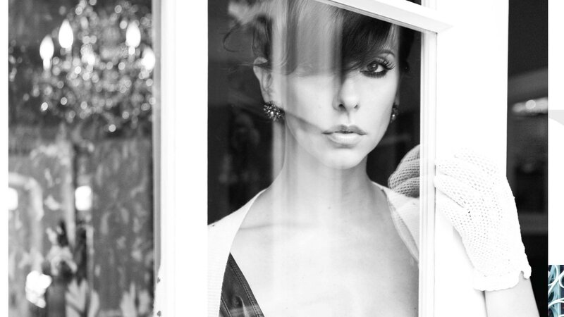 woman in white glove looking through window