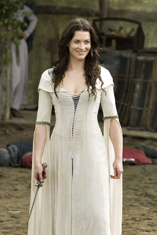 Woman in white gown holding sword