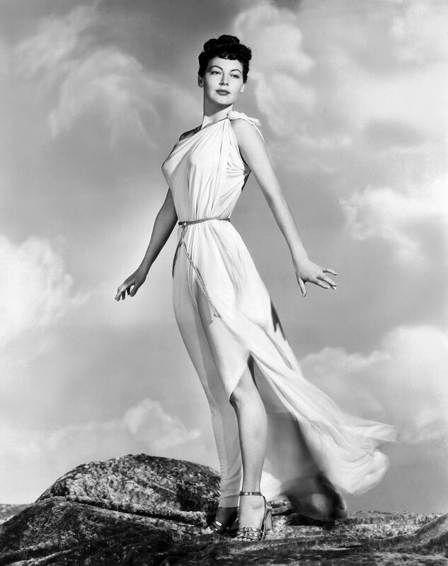 woman in white gown on rocks