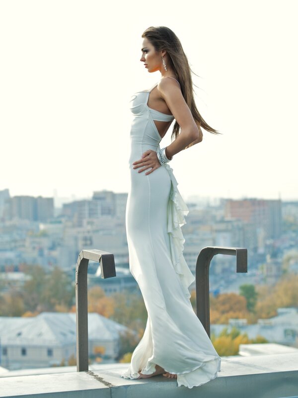 woman in white gown on rooftop