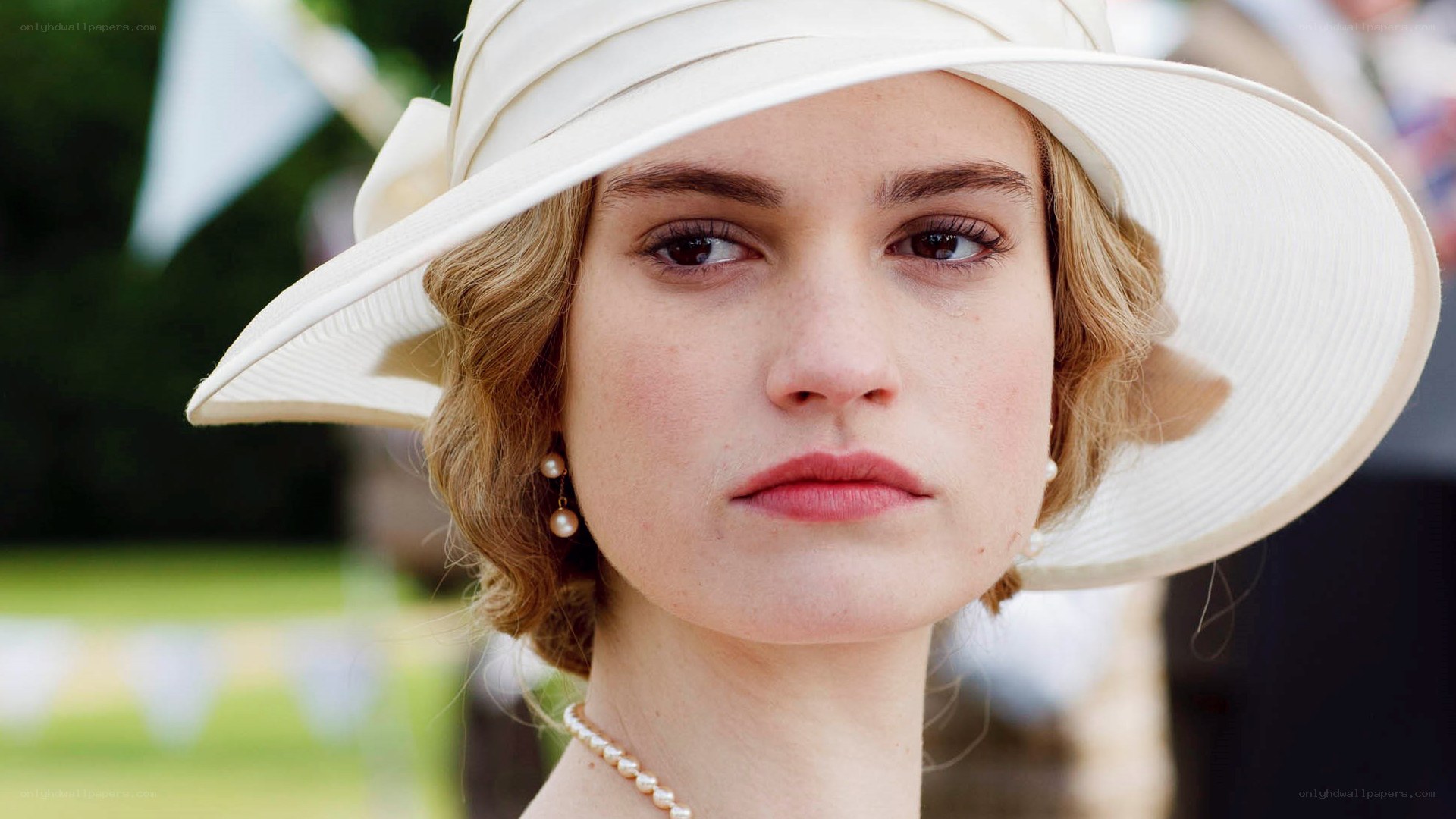 woman in white hat and pearls
