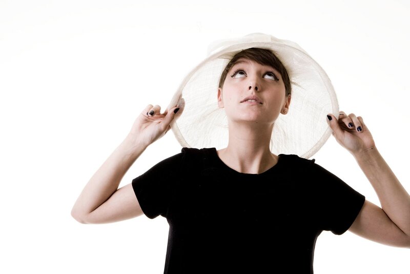 woman in white hat looking up