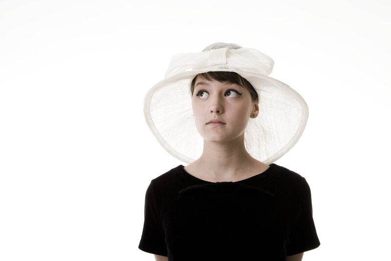 woman in white hat looking up