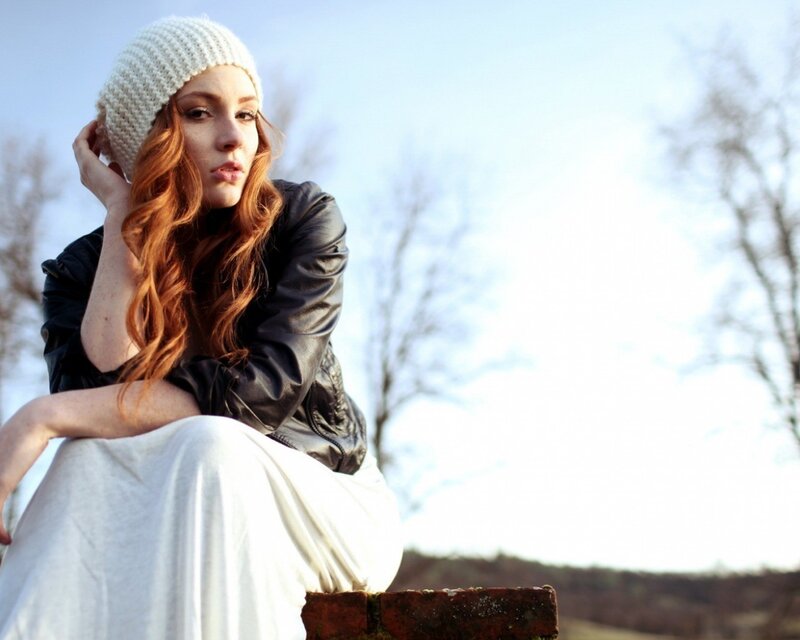woman in white hat sitting outside