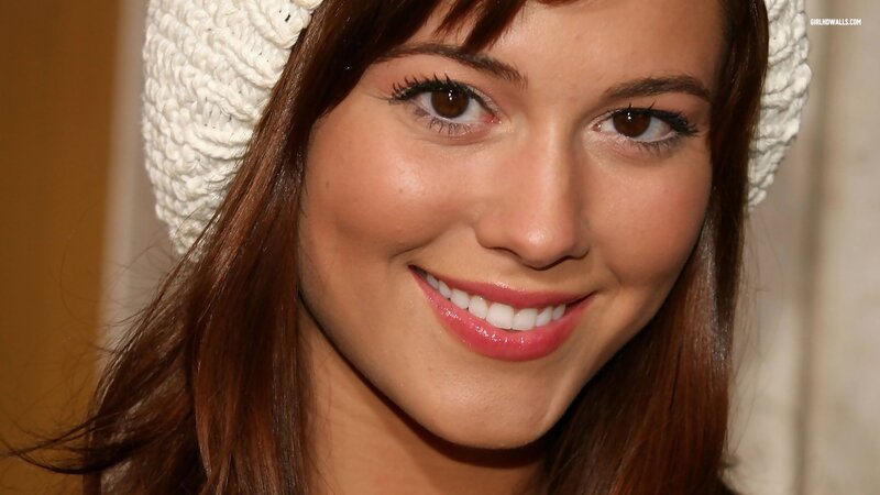 woman in white hat smiling
