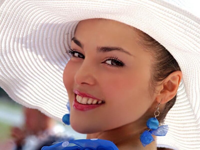 woman in white hat smiling