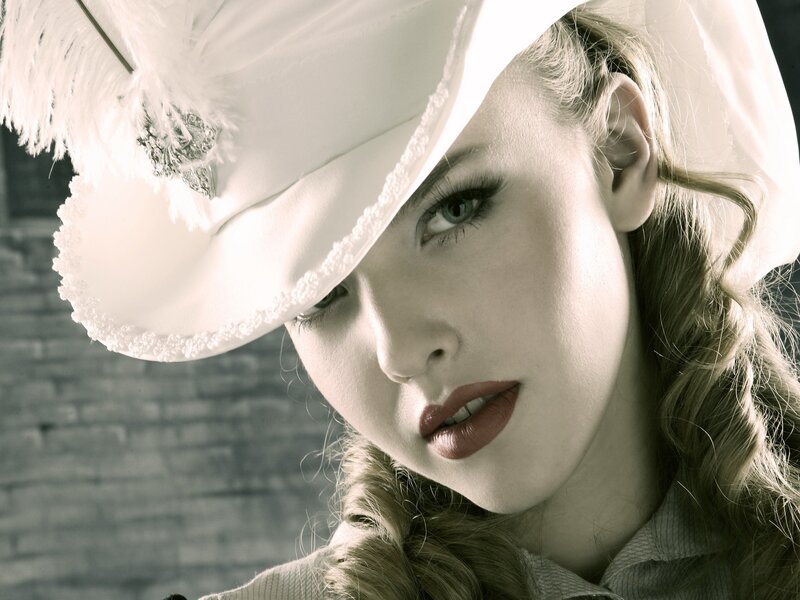 woman in white hat with feathers