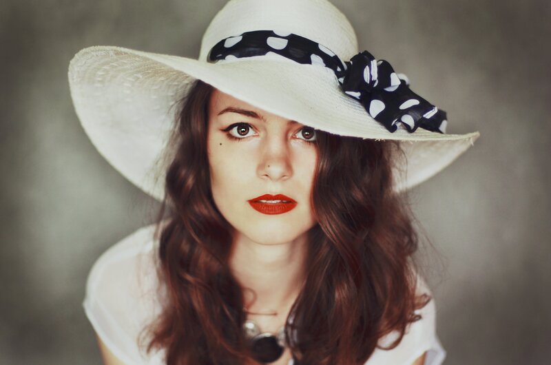woman in white hat with polka dot bow