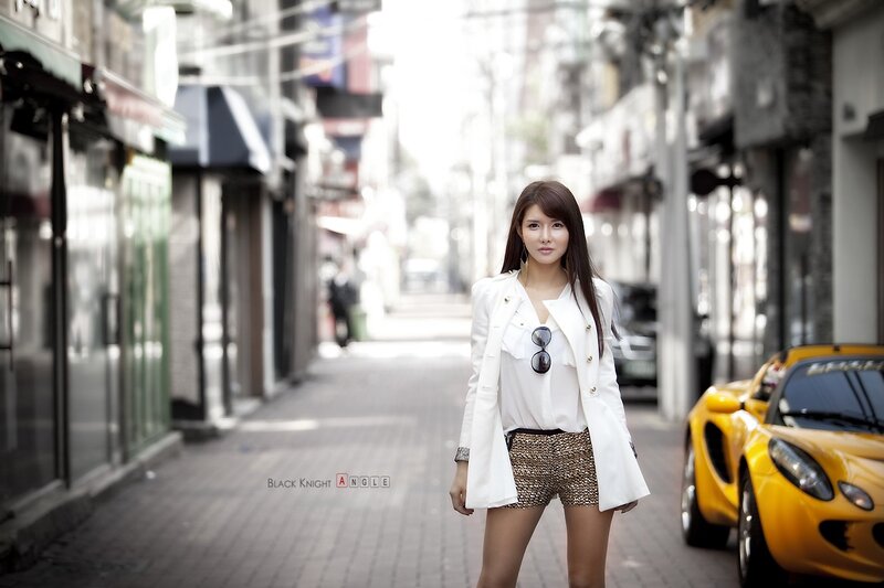 Woman in white jacket on street