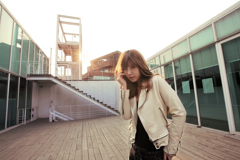 woman in white jacket on wooden deck