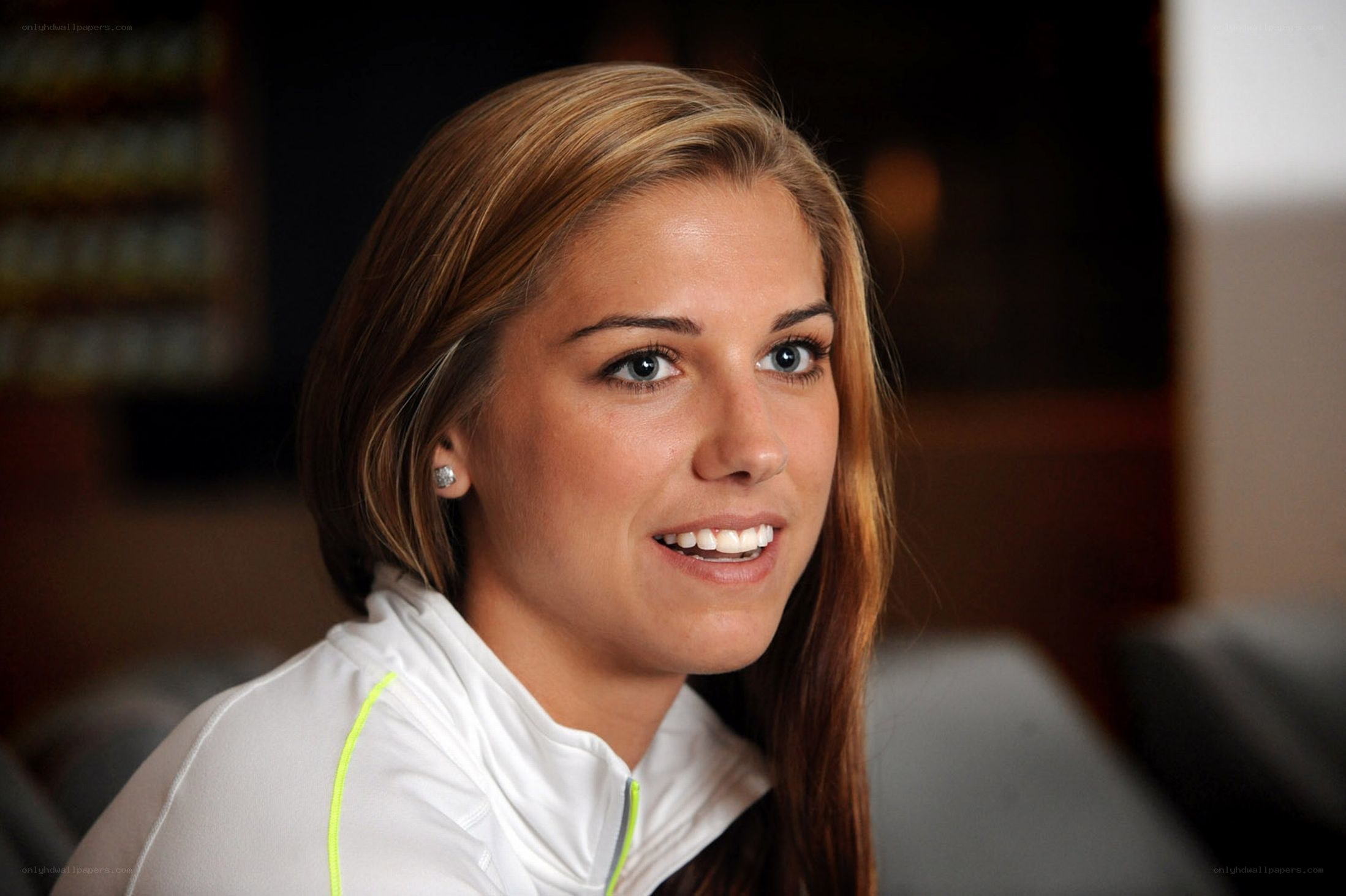 woman in white jacket smiling